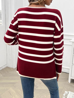 Burgundy and white striped oversized V-neck knit sweater with long sleeves.