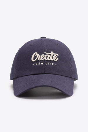 Navy baseball cap with embroidered "Create New Life" text detail.