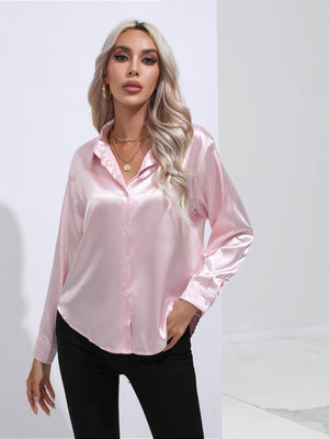 Blush pink satin button-front blouse with long sleeves and a collared neckline.