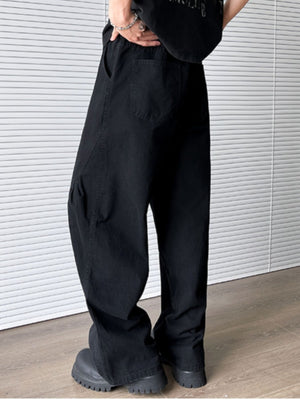 Men's black pocketed wide leg sweatpants with elastic waist and belt loops.