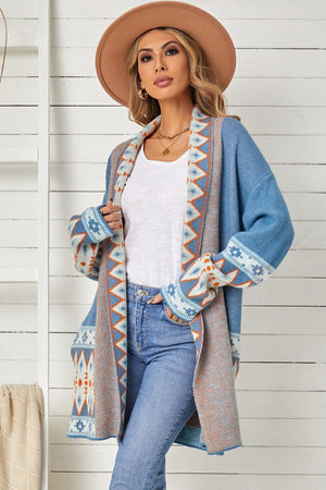Blue knit open-front cardigan with geometric trim and long sleeves.