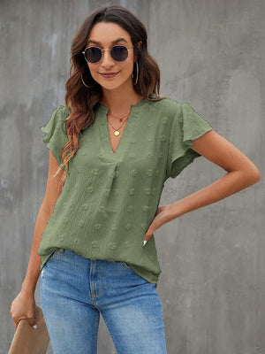 Flutter sleeve Swiss dot blouse in Matcha Green with a V-neckline.