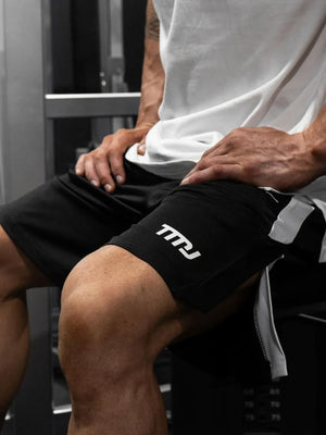 Black performance shorts with white logo detail and side panel