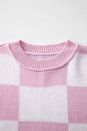 Checkerboard knit crewneck sweater in Dusty Pink and white acrylic with ribbed neckline.