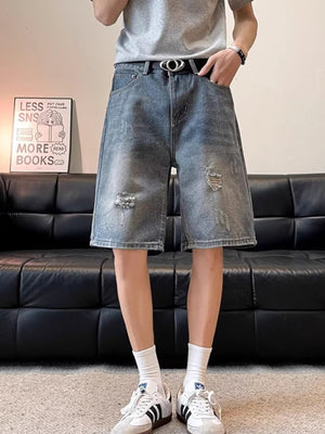 Men's distressed wide leg denim shorts in blue cotton with ripped details.