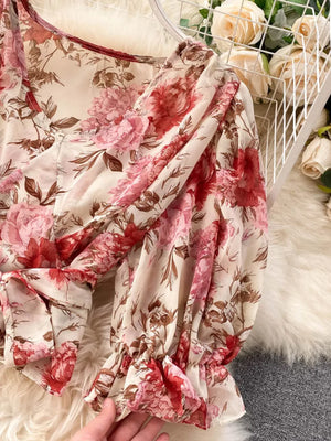 Chic floral crop top with puff sleeves and ruffled cuffs.