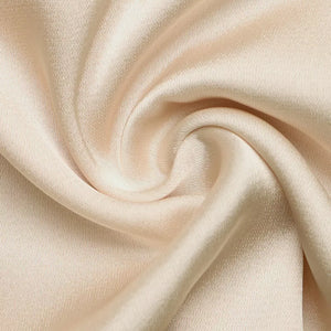 Pearl-trimmed satin luxe bodysuit in a soft beige hue, showcasing luxurious fabric texture.