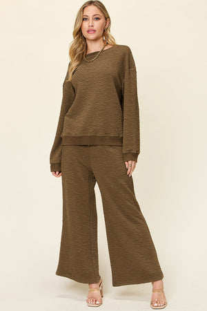 Textured lounge set in olive green with crew neck sweatshirt and wide leg pants.