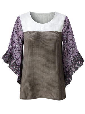 Textured panel blouse with white and gray waffle knit body and purple floral flutter sleeves.