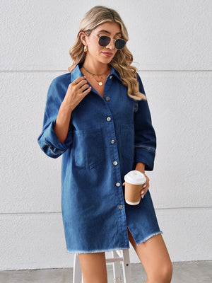 Dark blue denim shirt dress with raw hem, button front, and chest pockets.