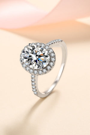 Silver pavé halo solitaire ring with a round-cut center stone and embellished band.
