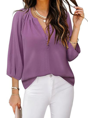 Lilac blouse with 3/4 sleeves, notched V-neck, and button detail.