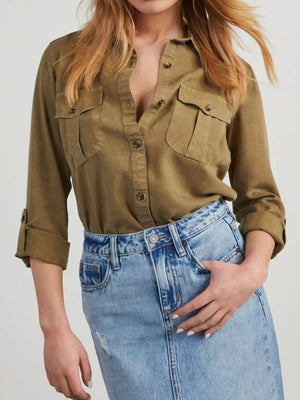Olive brown washed denim utility shirt with buttoned chest pockets and rolled sleeves.
