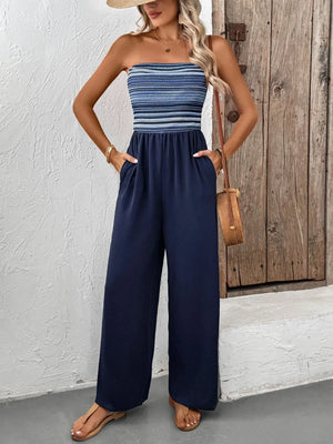 Dark blue bandeau palazzo jumpsuit with striped smocked bodice and wide legs.