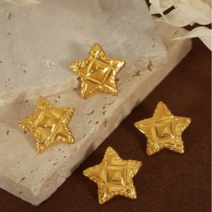 Gold textured celestial star stud earrings with a quilted pattern detail.