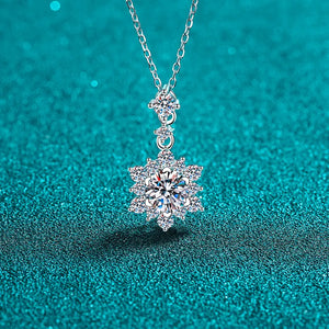 Silver moissanite pendant necklace with a floral halo design.