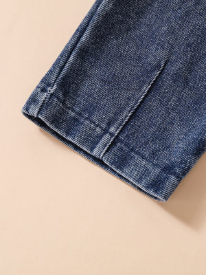 Acid-wash denim jeans detail, showing stitching and hem.