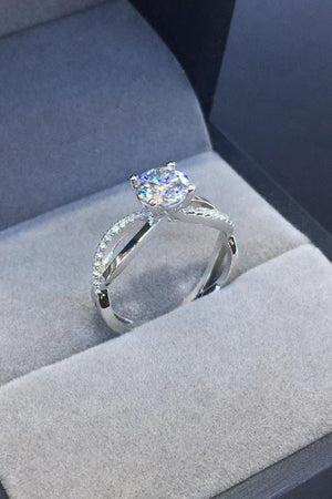 Silver crisscross diamond halo ring with a bright center stone.