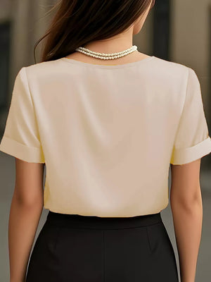 Apricot satin shirt with cuffed sleeves and V-neck, shown from the back.