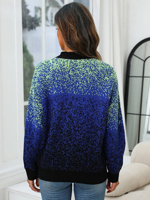 Speckled gradient knit cardigan in navy with a black collar and cuffs.