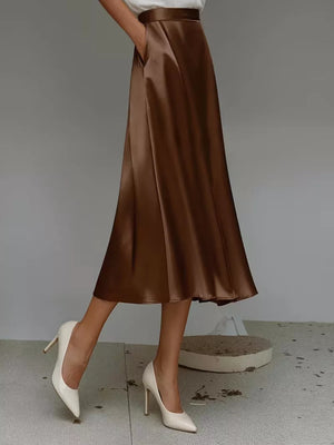 Elegant A-line satin skirt in dark brown with pockets.