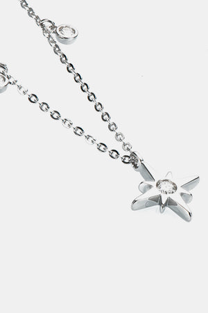 Silver celestial compass pendant necklace with moissanite charm and bezel-set cubic zirconia accents.