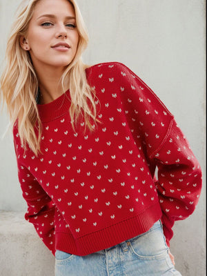 Dotted knit cropped crewneck sweater in Deep Red with a white dot pattern, crew neck, and ribbed cuffs.