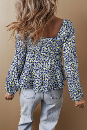 Daisy print peplum blouse in dusty blue with smocked bodice and square neckline.