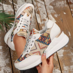 White leather wedge sneakers with colorful geometric pattern fabric and chunky sole.