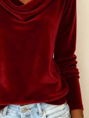 Red velvet cowl neck t-shirt with long sleeves, paired with light wash jeans.