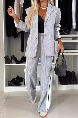 Light gray track stripe blazer and trouser set with white side stripes.