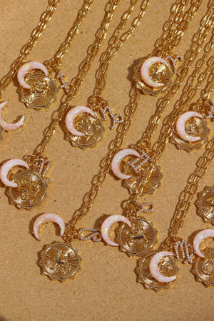 Gold zodiac pendant necklaces with opal crescent moons and diamond accents.
