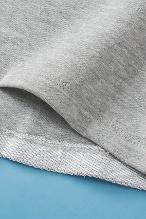 Light gray sweatshirt with a pocket detail and ribbed hem.