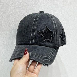 Black distressed baseball cap with embroidered stars and white contrast stitching.