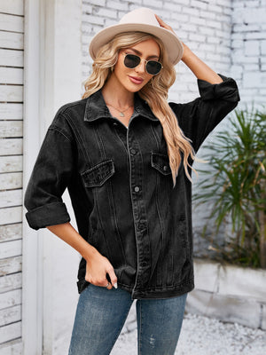 Black oversized denim trucker jacket with rolled sleeves and button front.