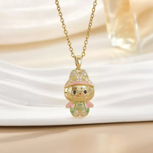 Gold-plated character pendant necklace with pink and green enamel details and crystal accents