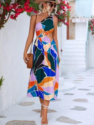 Abstract cutout midi dress with one shoulder and colorful geometric print.