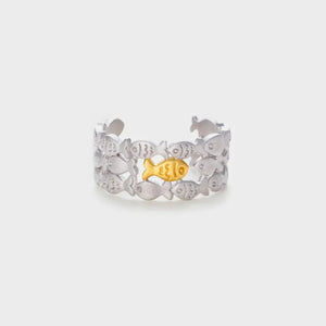 Adjustable ring with a school of silver fish and one gold fish in the center.