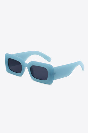Teal acetate rectangle sunglasses with dark lenses and thick frames.