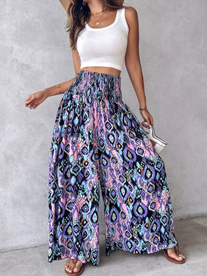 Bohemian print wide-leg pants with smocked waist in purple, pink, and blue.