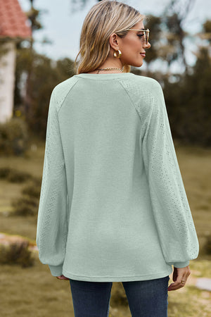 Light green waffle knit raglan v-neck top with eyelet detail on sleeves.