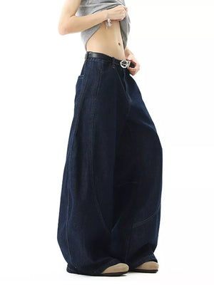 Men's dark wash cotton jeans with oversized wide legs and pockets.