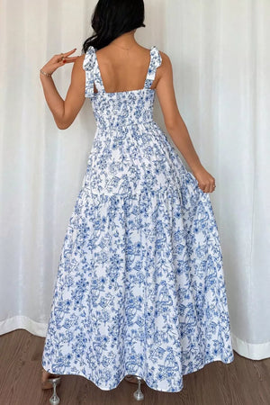 Maxi dress with blue floral print, smocked bodice, and tie straps.