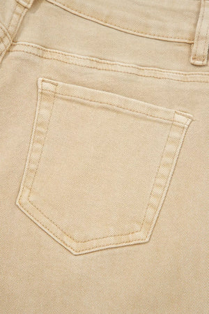 Beige denim jeans with a visible back pocket detail and contrast stitching.