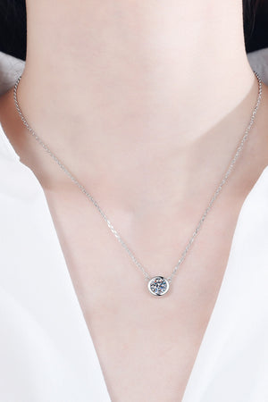 Silver solitaire diamond necklace with bezel setting on a delicate chain.