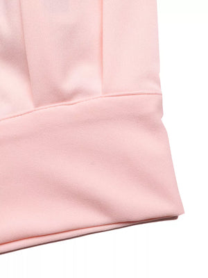 Pink pleated midi skirt set detail showing fabric texture and pleats.