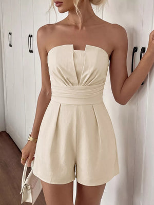 Cream pleated V-neck strapless romper with a cinched waist and short legs.
