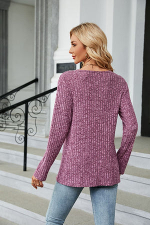 Ribbed tunic top in red-violet with button detail and asymmetric hem.
