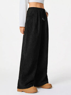 Black corduroy maternity cargo pants with drawstring waist and wide legs.