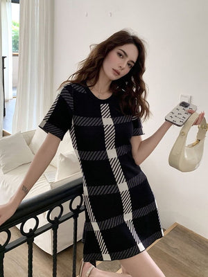 Black and white plaid mini dress with short sleeves and a round neckline.